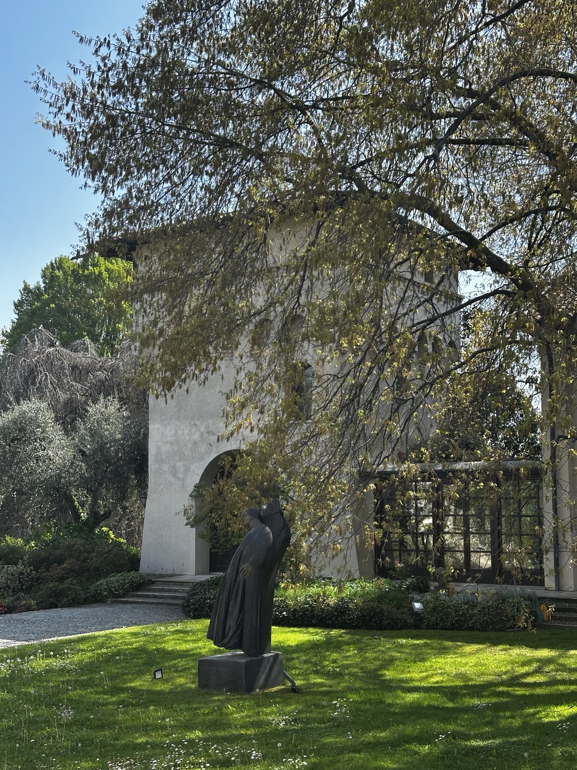 Sculpture and medieval tower in the garden